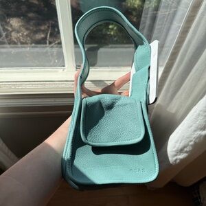 Edas Yshaia mini handbag in sapphire blue with white buckle